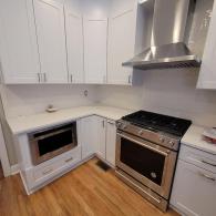Newly remodeled all white kitchen with stainless steel appliances