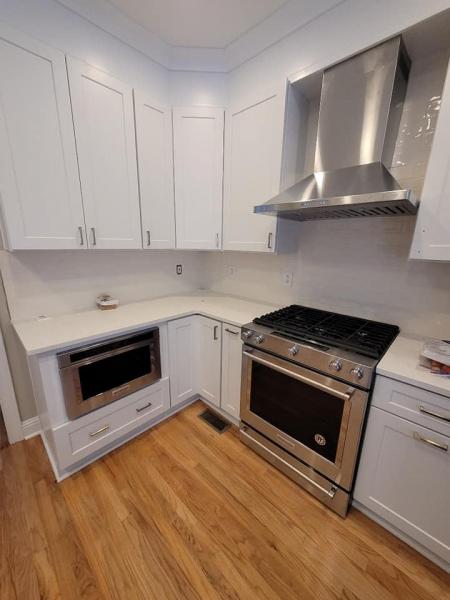 Newly remodeled all white kitchen with stainless steel appliances