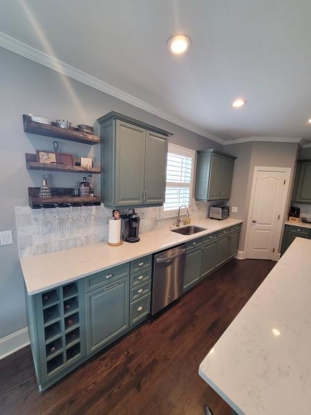 Kitchen renovation with gray cabinets and white countertops