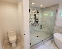 Bathroom renovation featuring modern soaking tub and glass shower