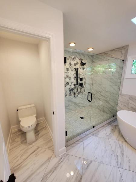 Bathroom renovation featuring modern soaking tub and glass shower