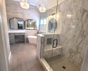 Large glass shower with marble tile