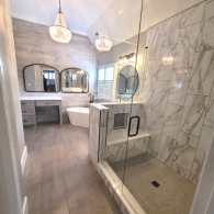 Large glass shower with marble tile