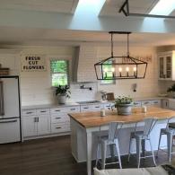 Kitchen renovation featuring butcher block island and shiplap backsplash