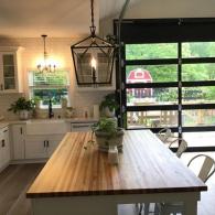 Butcher block kitchen island with roll up glass door to patio