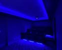 Home theater room with feature lighting