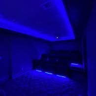 Home theater room with feature lighting
