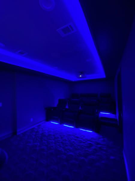 Home theater room with feature lighting
