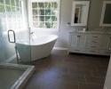 Soaking tub in front of two large windows
