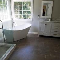Soaking tub in front of two large windows