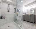 Bathroom with large glass shower and double vanity