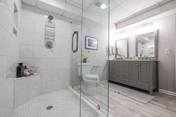 Bathroom with large glass shower and double vanity